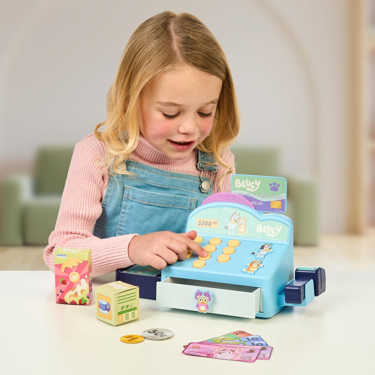 Bluey Cash Register. Press The Buttons to Hear Beeps, Sounds and Phrases from Bluey and Bingo |Use The Scanner to Scan Packages and Pretend to Run a Shop | Includes Toy Credit Card and Dollar Bucks!