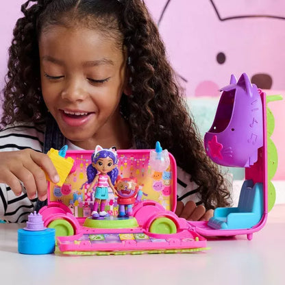 Child playing with Gabby's Dollhouse Party Bus, showing DJ booth transformation, dance floor, and included Gabby Girl and DJ Catnip figures.